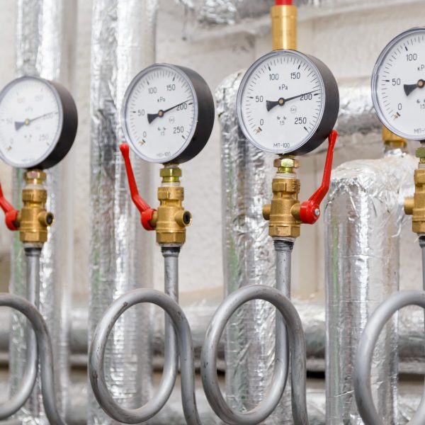 Set of manometers in industrial heating system in a boiler room.
